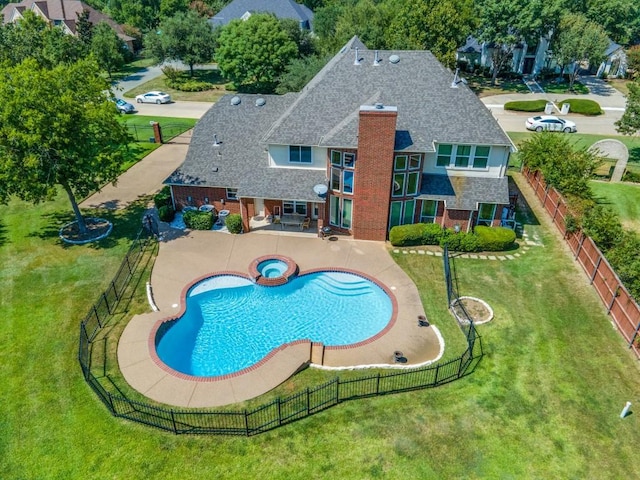 view of swimming pool with a patio, a lawn, a fenced backyard, and a pool with connected hot tub