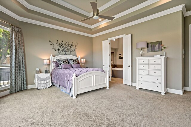 bedroom featuring carpet flooring, ceiling fan, ensuite bathroom, a tray ceiling, and ornamental molding