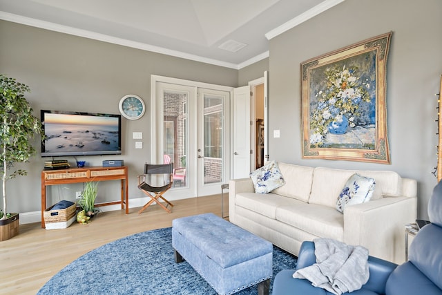 living room with ornamental molding, french doors, and hardwood / wood-style flooring