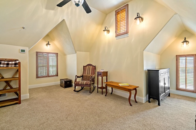 living area featuring plenty of natural light, ceiling fan, and light colored carpet