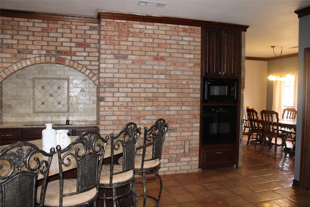 dining space with dark tile patterned flooring, crown molding, and brick wall