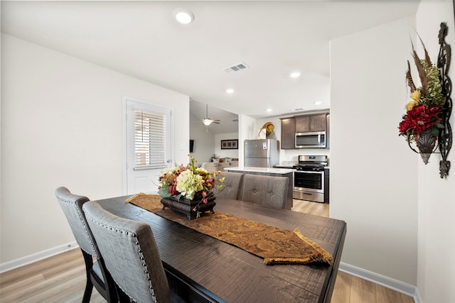 dining space featuring ceiling fan and light hardwood / wood-style flooring