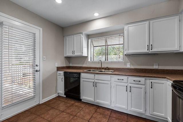 kitchen featuring white cabinets, sink, dark tile patterned flooring, and black appliances