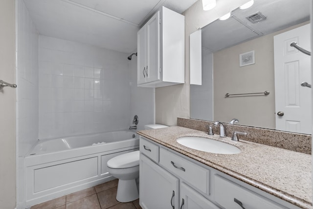 full bathroom with tiled shower / bath, tile patterned flooring, vanity, and toilet