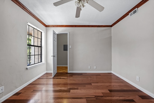 spare room with a textured ceiling, dark hardwood / wood-style floors, ceiling fan, and crown molding