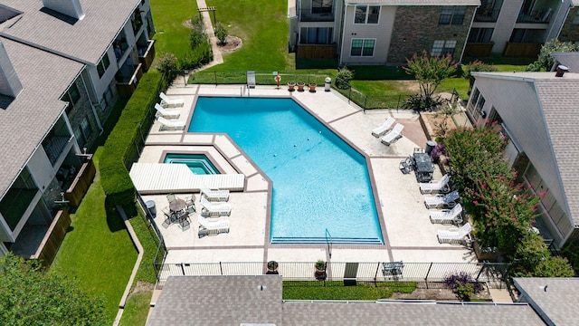 pool with a patio and fence