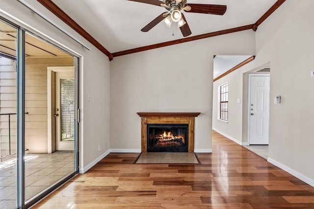 unfurnished living room with hardwood / wood-style flooring, vaulted ceiling, ceiling fan, and ornamental molding