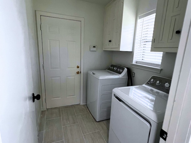 washroom with cabinets and separate washer and dryer