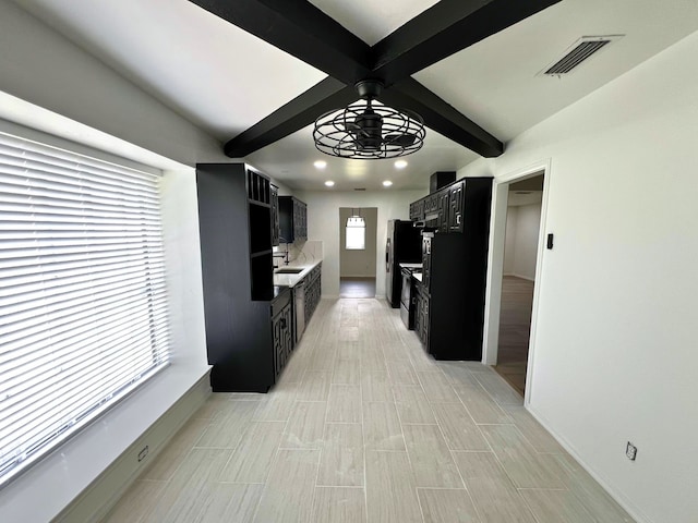 kitchen featuring sink and beamed ceiling