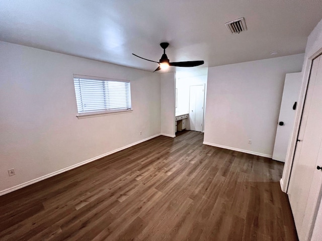 unfurnished bedroom featuring ceiling fan and dark wood-type flooring