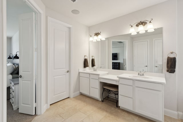 bathroom with tile patterned floors and vanity