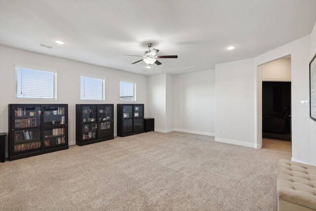 unfurnished living room with ceiling fan and light carpet