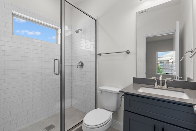 bathroom with an enclosed shower, toilet, and vanity