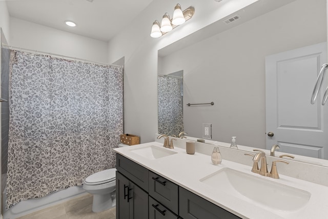 bathroom featuring tile patterned floors, toilet, and vanity