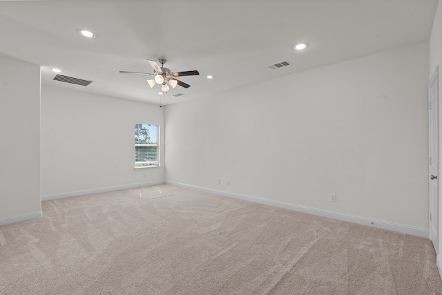 carpeted spare room with ceiling fan