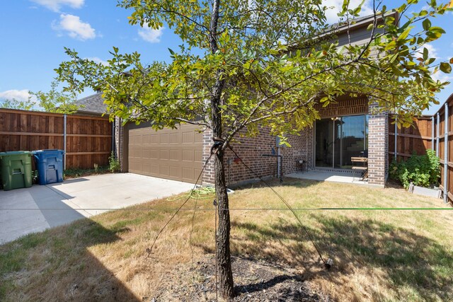 view of yard featuring a patio and a garage