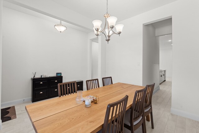 dining room with an inviting chandelier and light hardwood / wood-style floors