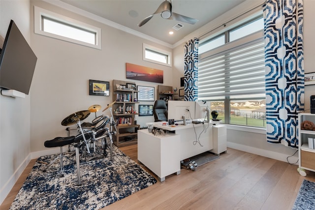 office featuring light hardwood / wood-style flooring, a healthy amount of sunlight, ceiling fan, and crown molding