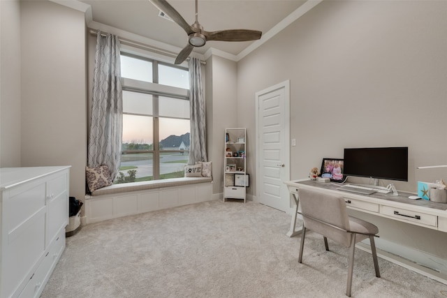 carpeted home office featuring crown molding and ceiling fan