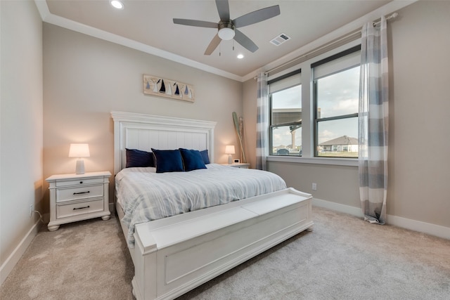 bedroom featuring light carpet, crown molding, and ceiling fan