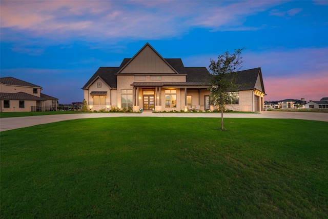 view of front of property featuring a yard and a garage