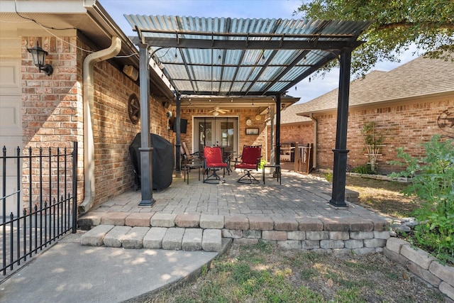 view of patio / terrace with french doors, fence, and a pergola