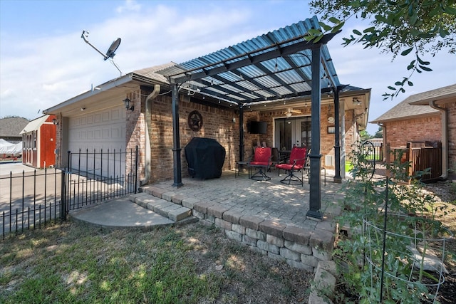 exterior space with concrete driveway, grilling area, an attached garage, and fence