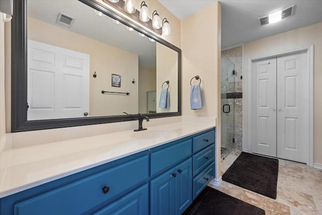 bathroom with a stall shower, a closet, visible vents, and vanity