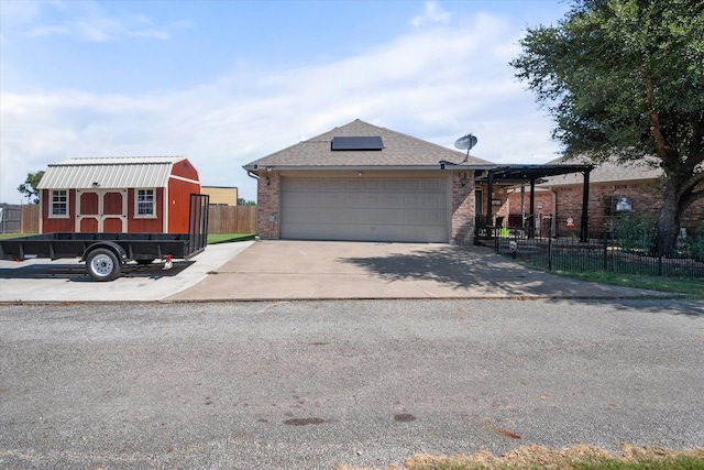 view of front of property with a garage, brick siding, a shingled roof, fence, and concrete driveway