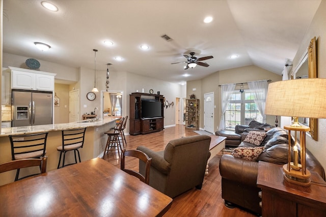 living area with dark wood-style floors, recessed lighting, lofted ceiling, visible vents, and ceiling fan