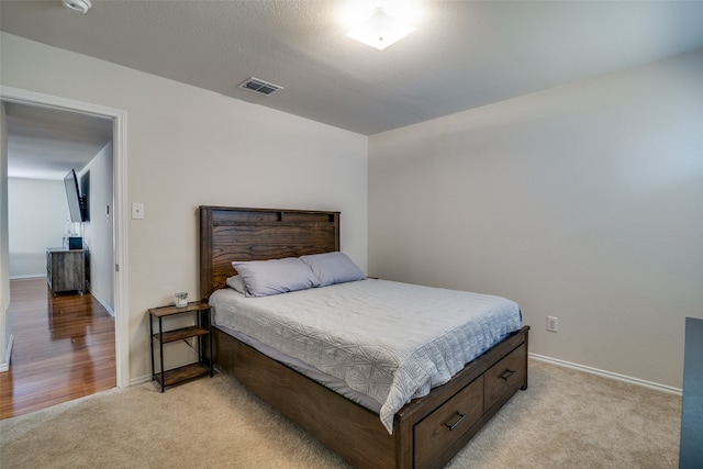 bedroom featuring light colored carpet