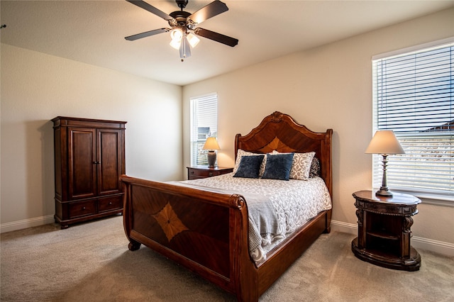 bedroom with ceiling fan and light colored carpet