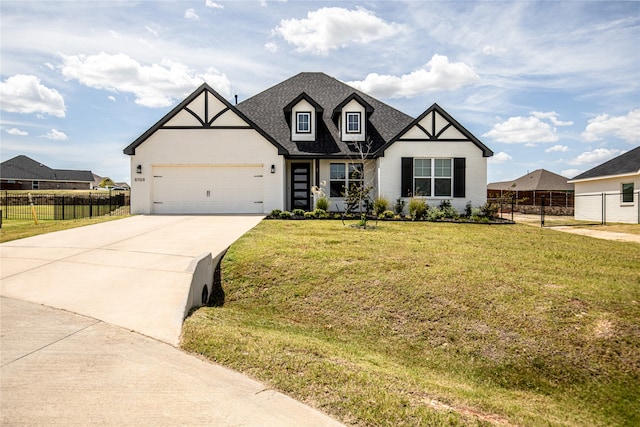 view of front of property with a garage and a front lawn