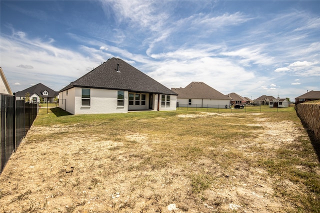 rear view of property with a yard