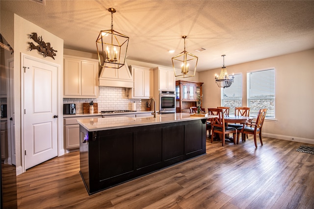 kitchen featuring decorative light fixtures, white cabinetry, dark hardwood / wood-style floors, and appliances with stainless steel finishes