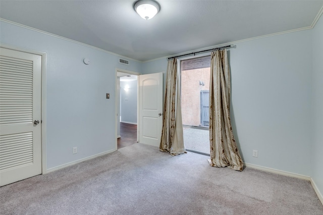 unfurnished bedroom featuring ornamental molding, visible vents, carpet floors, and baseboards