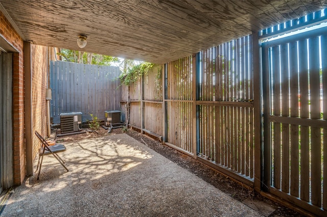 view of patio / terrace featuring central AC and fence