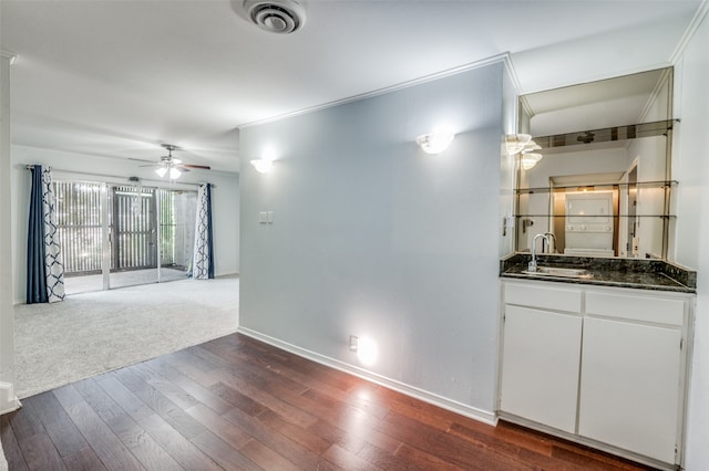 spare room with sink, carpet floors, and ceiling fan