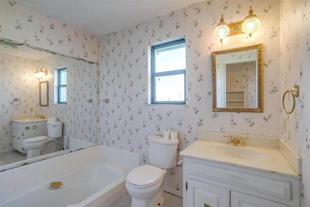 bathroom featuring a bath, a textured ceiling, vanity, and toilet