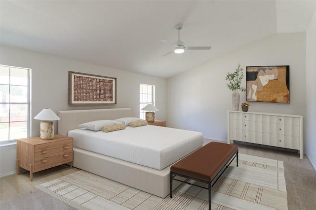 carpeted bedroom with ceiling fan and vaulted ceiling