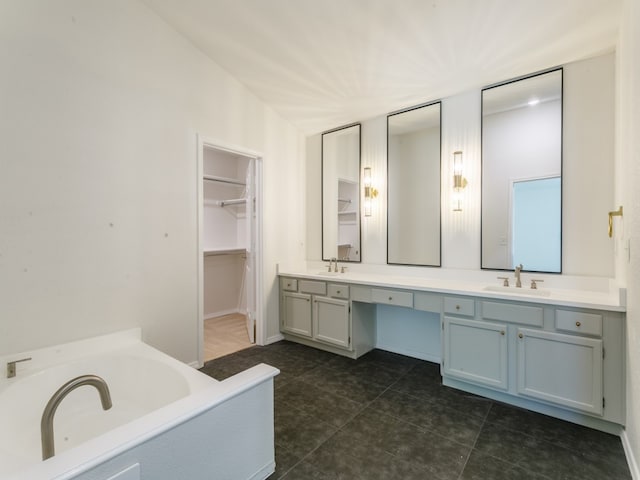 bathroom featuring a bath, dual bowl vanity, tile patterned flooring, and lofted ceiling