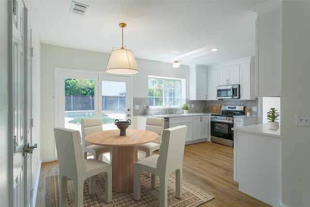 dining space featuring light wood-type flooring