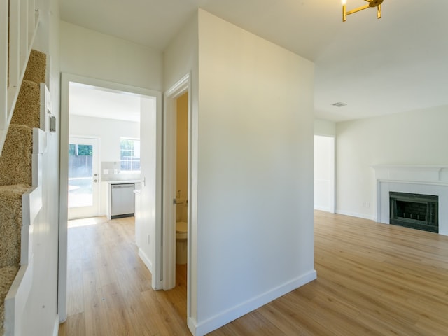 hallway with light hardwood / wood-style flooring