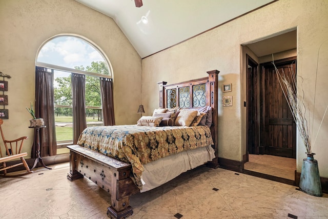 bedroom with ceiling fan and high vaulted ceiling