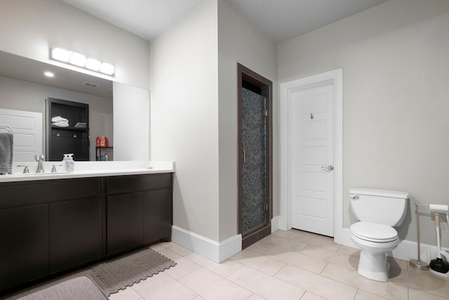 bathroom with tile patterned flooring, a shower, toilet, and vanity