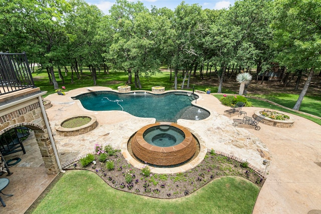 view of pool featuring a patio, a yard, and an in ground hot tub