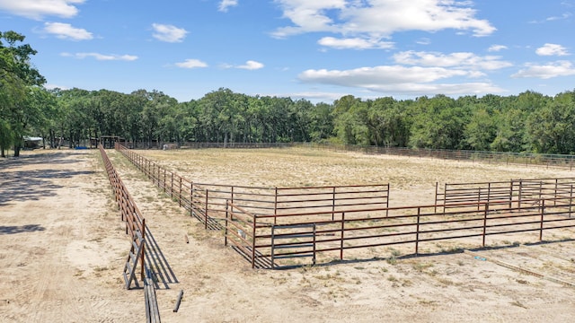 view of horse barn with a rural view