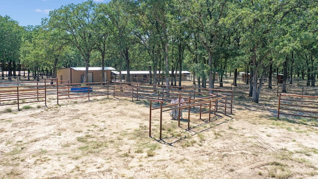 view of yard with a rural view and an outdoor structure