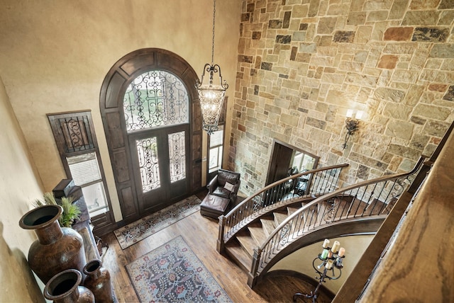 foyer entrance with a high ceiling, hardwood / wood-style flooring, and french doors