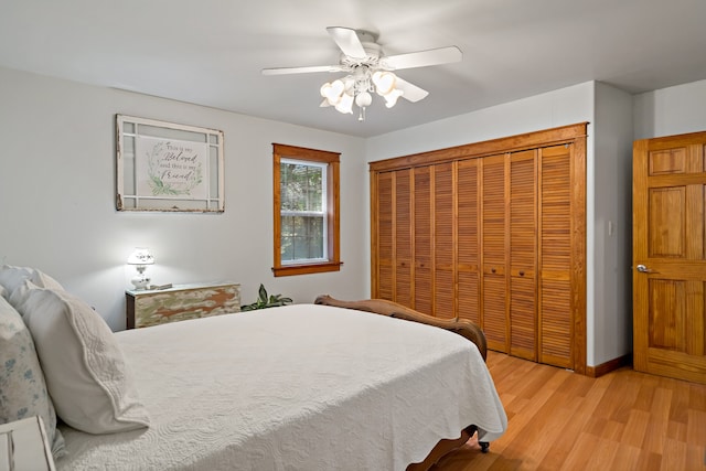 bedroom with ceiling fan, light hardwood / wood-style flooring, and a closet